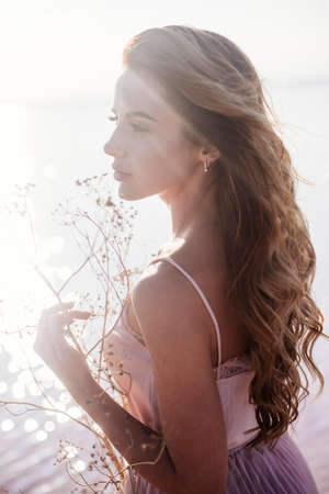 Beautiful girl on a pink lake.の写真素材