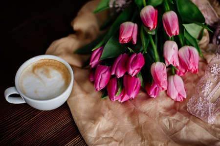 Cup of cappuccino and tulips.の写真素材