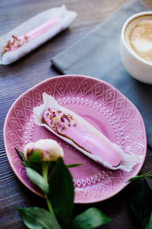 Cappuccino, eclairs and flowers.
