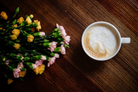 Cup of cappuccino and flowers.の写真素材