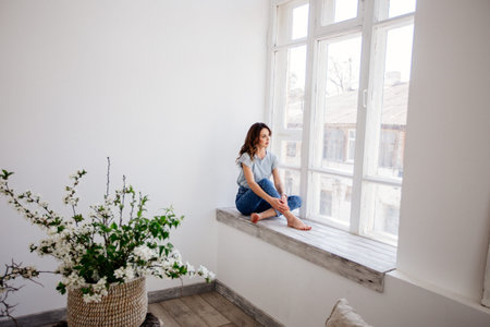 Beautiful girl by the window.
