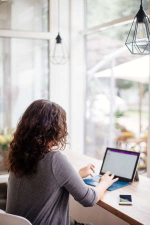 Girl with a laptop in a cafe.の写真素材
