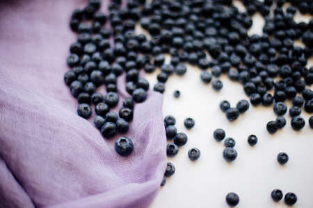Berries blueberries on a table with a purple clothの写真素材