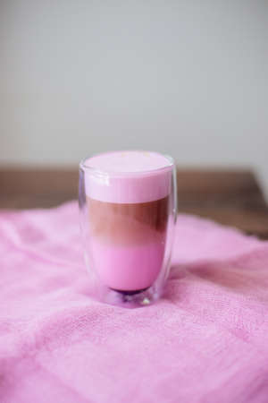 Pink latte on the table in the cafe.の写真素材