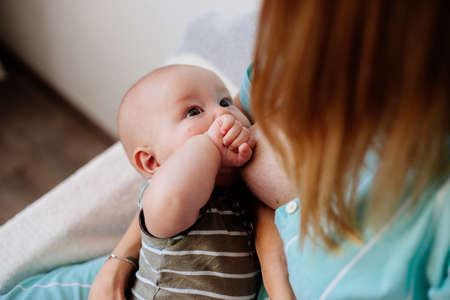 Mum is breastfeeding a child.の写真素材