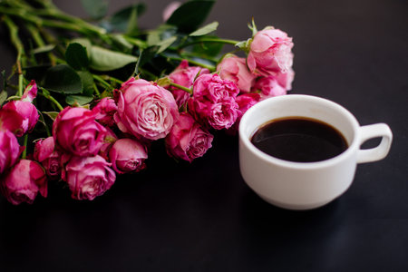 Cappuccino, eclairs and flowers.の写真素材