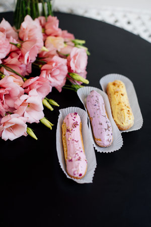 Cappuccino, eclairs and flowers.