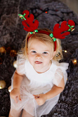 Baby girl with deer horns.の写真素材