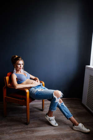 Beautiful pregnant young woman near the wall.の写真素材