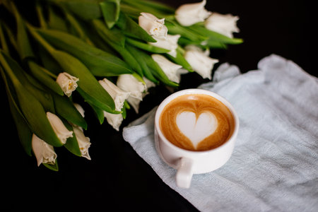 Cup of cappuccino and tulips.の写真素材