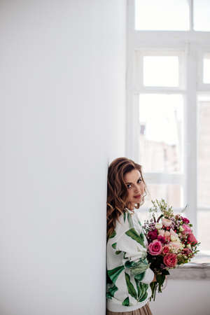 Florist makes a bouquet at light room.の写真素材
