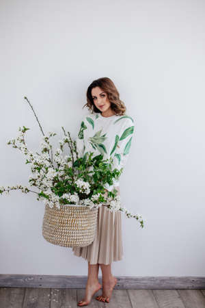 Basket of blooming tree in girl hands.の写真素材