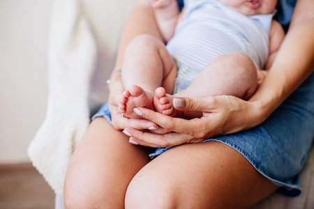 The legs of the baby in the hands.の写真素材