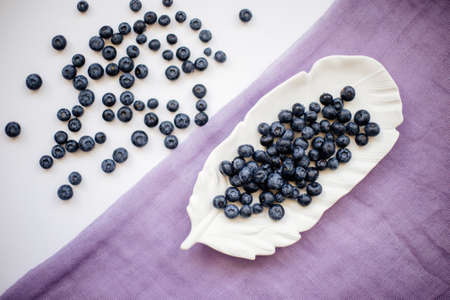 Blueberries on a white table.の写真素材