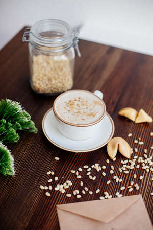 Cappuccino with nuts on the table.の写真素材