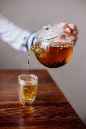 Pouring Herbal Tea. Autumn concept.の写真素材