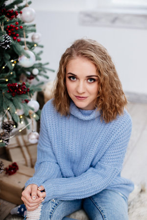 Beautiful woman at Christmas tree