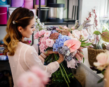 Florist woman makes a bouquet.の写真素材
