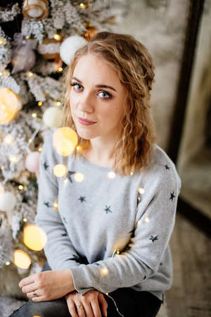 Beautiful woman at Christmas treeの写真素材