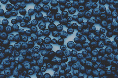 Blueberries. Blue background. Closeup flatlay.