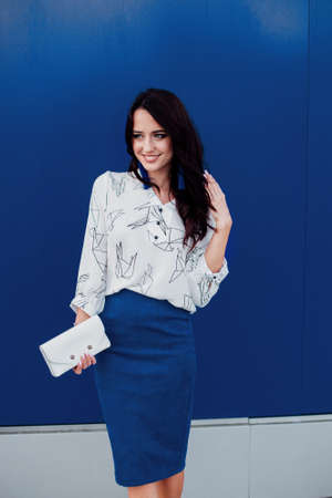 Woman on a background of blue color wall.の写真素材
