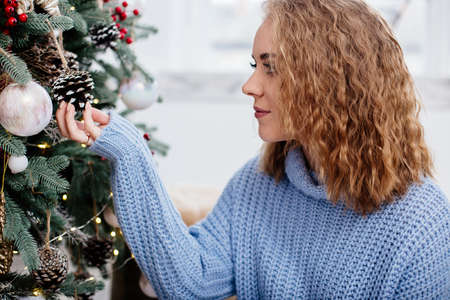 Beautiful woman at Christmas treeの写真素材