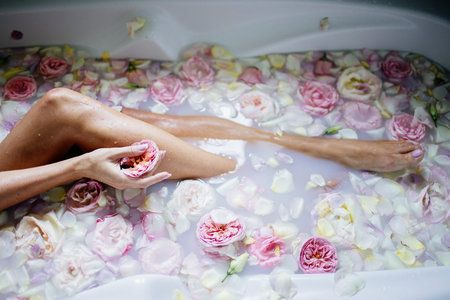Beautiful girl in the bathroom with many flowers.の写真素材