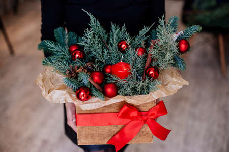 Christmas wreath of fir branches with red decor and a cup of cocoa with marshmallows on a wooden table. New Year and Christmas concept.の写真素材