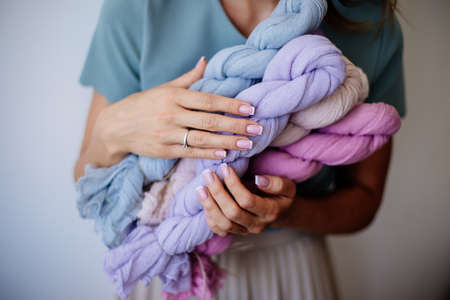Florist with colored gauze in hands.の写真素材