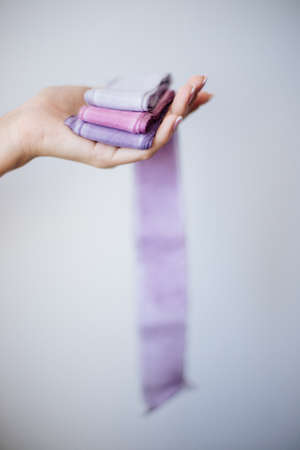 Accessories florist silk ribbons in hand.の写真素材