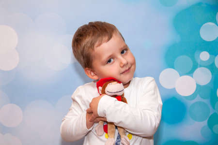 Child Emotions. Funny boy. A boy with blue eyes. Portrait. With a toy in his handsの写真素材
