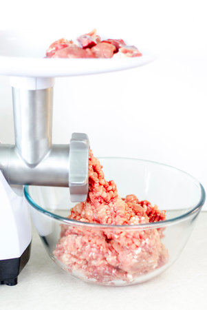 Meat in a meat grinder. Food preparation. Meat for cutlets. Production. Minced meat.