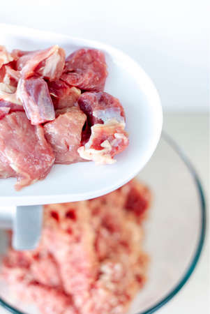 Meat in a meat grinder. Food preparation. Meat for cutlets. Production. Minced meat.の写真素材