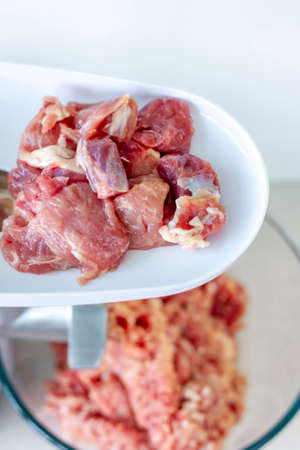 Meat in a meat grinder. Food preparation. Meat for cutlets. Production. Minced meat.の写真素材