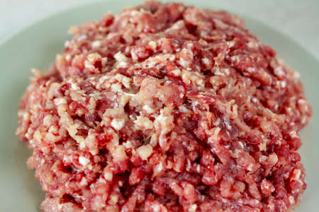 Meat in a meat grinder. Food preparation. Meat for cutlets. Production. Minced meat.の写真素材