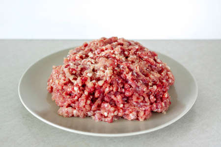Meat in a meat grinder. Food preparation. Meat for cutlets. Production. Minced meat.の写真素材