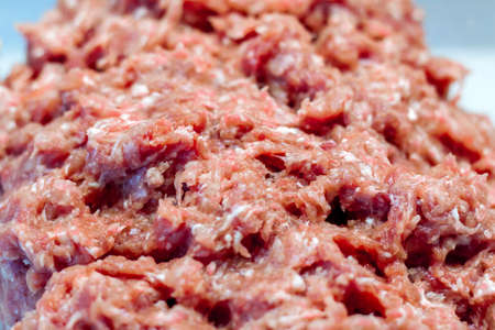 Meat in a meat grinder. Food preparation. Meat for cutlets. Production. Minced meat.の写真素材