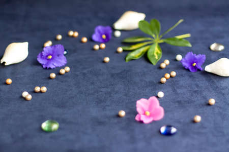Background for the design. Beads. Green leaf. Various decor elements. Bright flowers. Easy base. Dark background.の写真素材