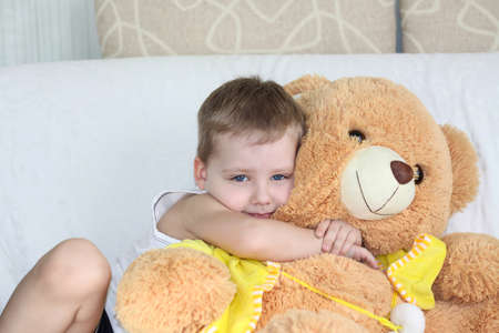 A boy with a funny expression on his face. With a toy. Emotions, portrait.の写真素材