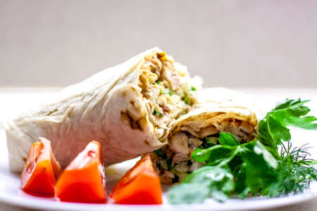 Cooking rolls with meat and vegetables. Roll in flatbread. Food preparation.の写真素材