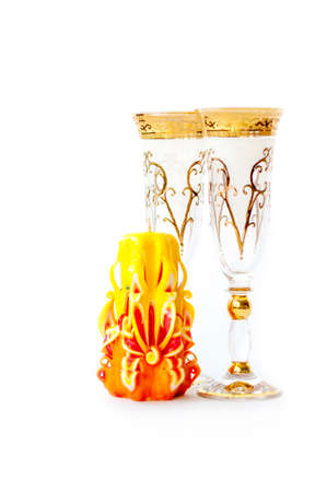 Beautiful, carved, yellow candle on a white background. Items for registration. Wedding candle.の写真素材