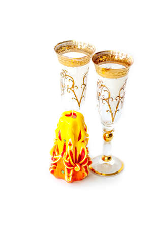 Beautiful, carved, yellow candle on a white background. Items for registration. Wedding candle.の写真素材