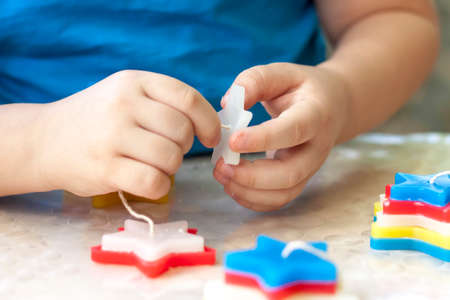 Creativity with children. Making candles for the holiday. Making crafts with children. Candles in the form of stars.の写真素材