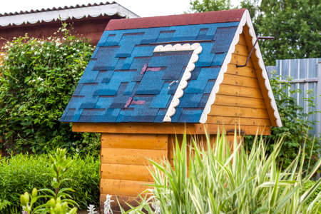 A beautiful village well with a blue roof. A well with drinking water stands in the village courtyard.の写真素材
