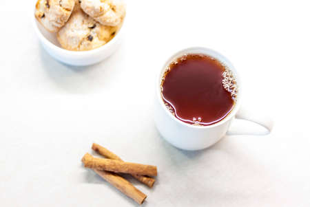 Tea with fragrant cookies, cinnamon and jam. Tea with sweets. Light and light composition of objects.の写真素材