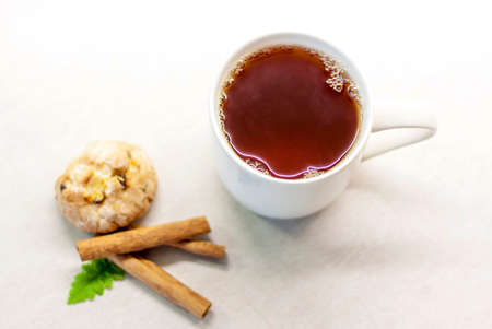 Tea with fragrant cookies, cinnamon and jam. Tea with sweets. Light and light composition of objects.の写真素材