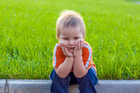 Child. Playing in the yard. Baby's emotions. Summer. Sunny day. Happy baby.の写真素材
