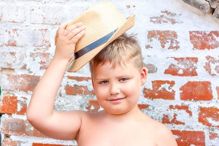 Portrait of a boy in a hat. A child poses in a beautiful hat.の写真素材