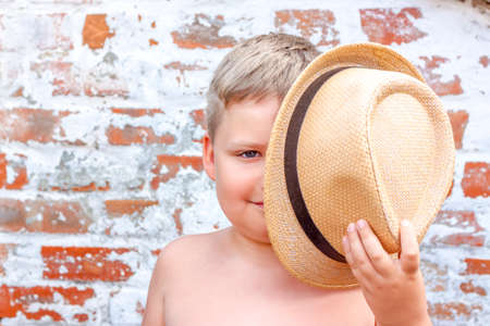 Portrait of a boy in a hat. A child poses in a beautiful hat.の写真素材