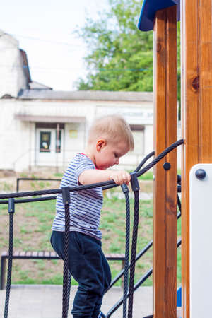 A little boy plays with passion on the Playground. Success, bright idea, creative ideas and sports concepts. Concept for an advertising banner.の写真素材